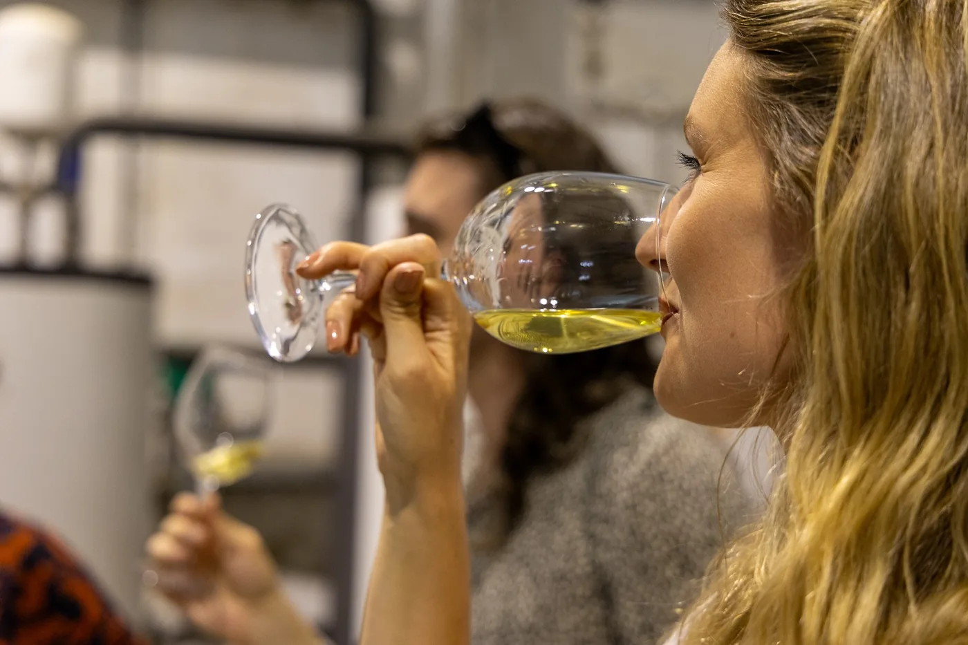 Guest tasting white wine during a winery visit in Portugal.