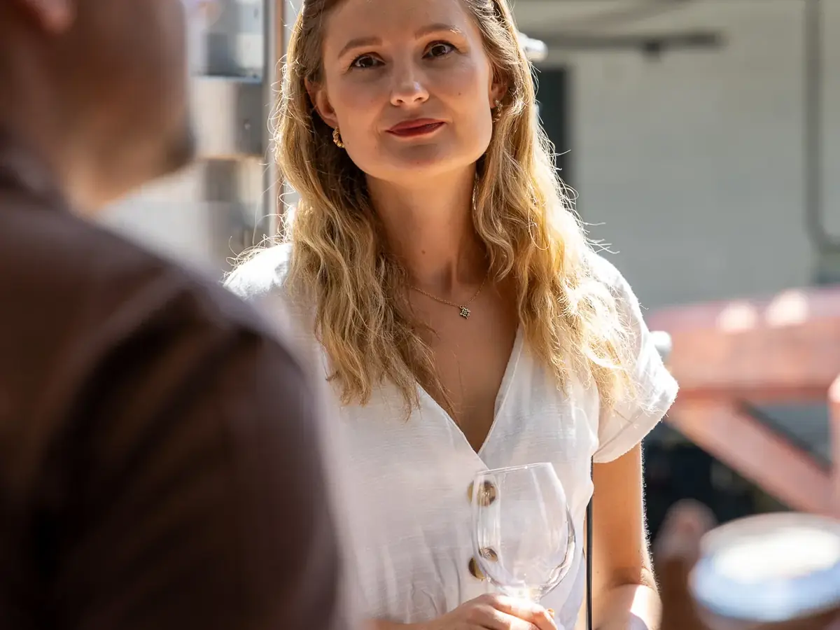 Guest listening to a winery host during a wine tasting experience in Setúbal, Portugal