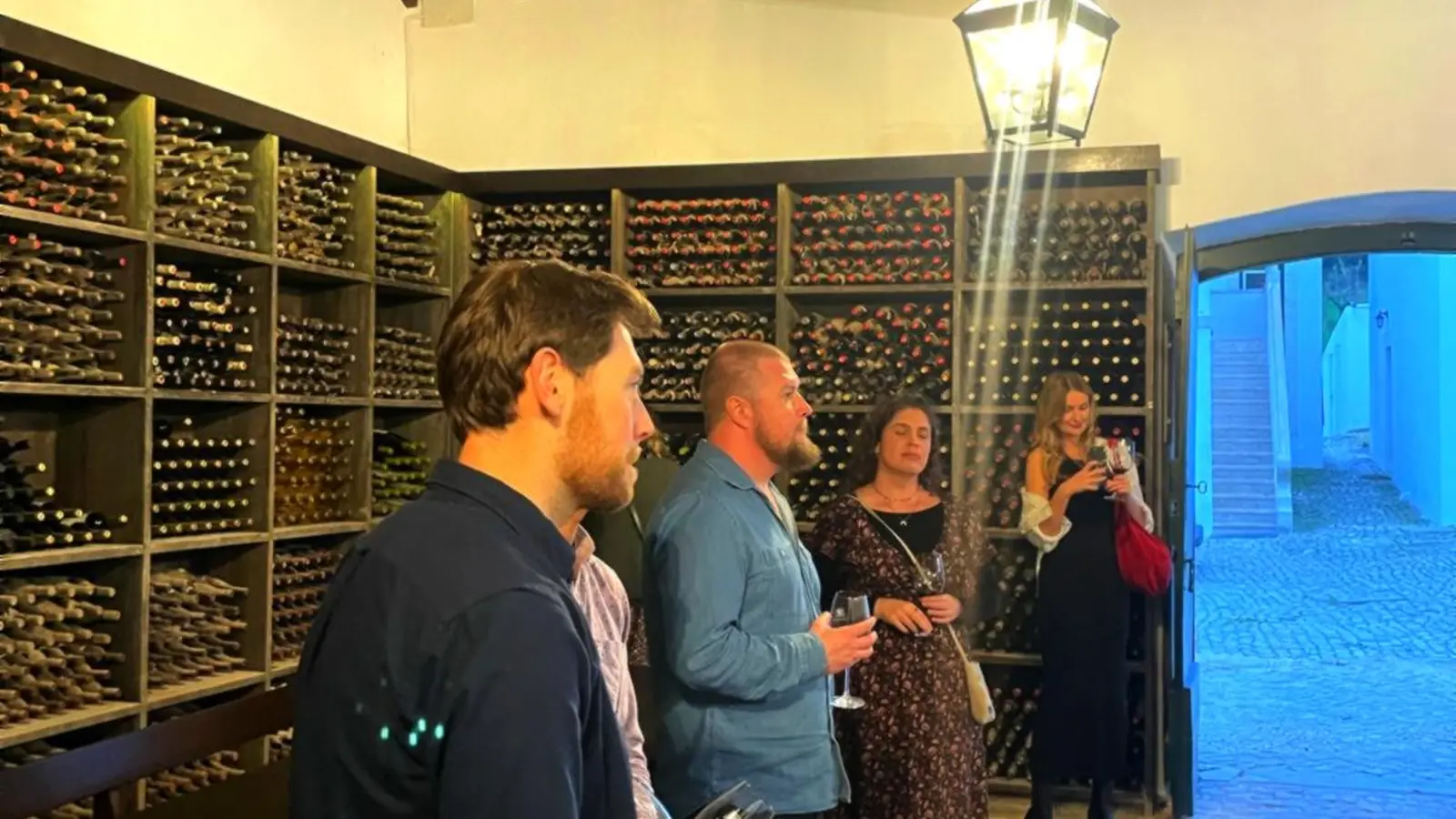Guests enjoying a private wine tasting in a historic Portuguese wine cellar as part of a bespoke wine journey.